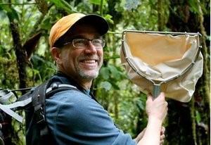 Dr. Eric Snyder smiles for the camera holding a D-net invertebrate sampler.